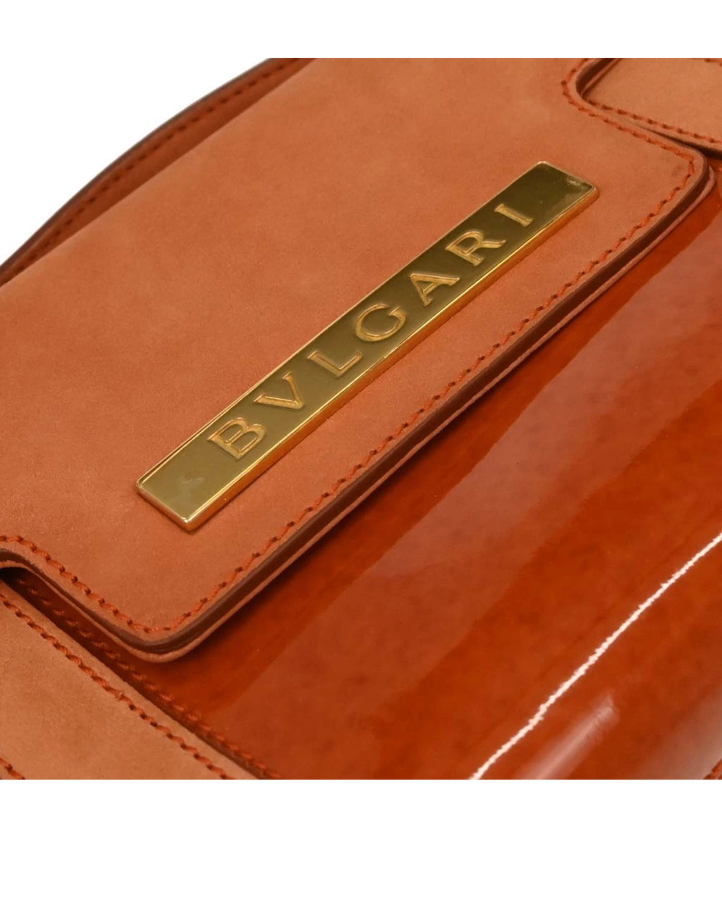Close-up of a Bvlgari leather product with gold logo.