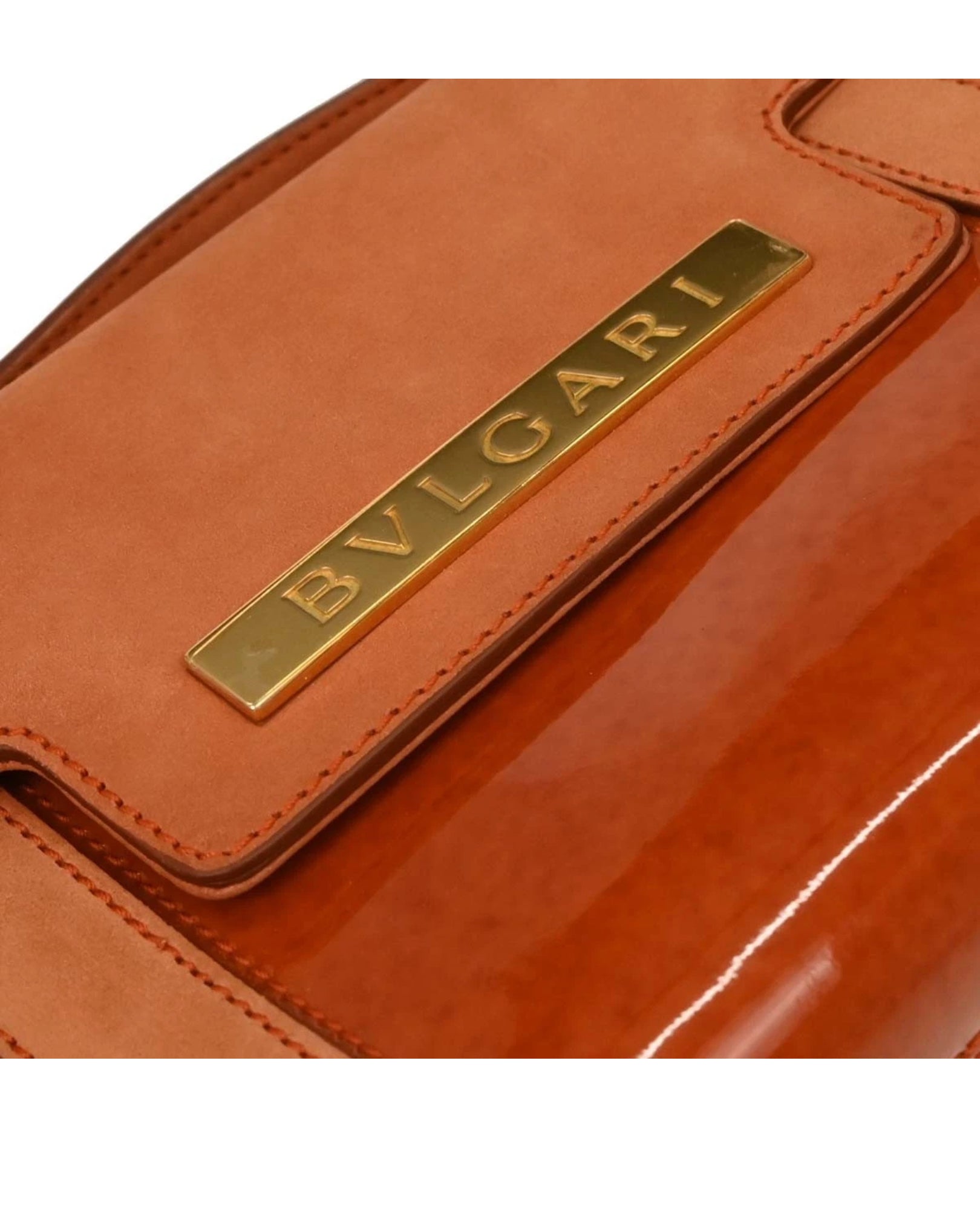 Close-up of a Bvlgari leather product with gold logo.