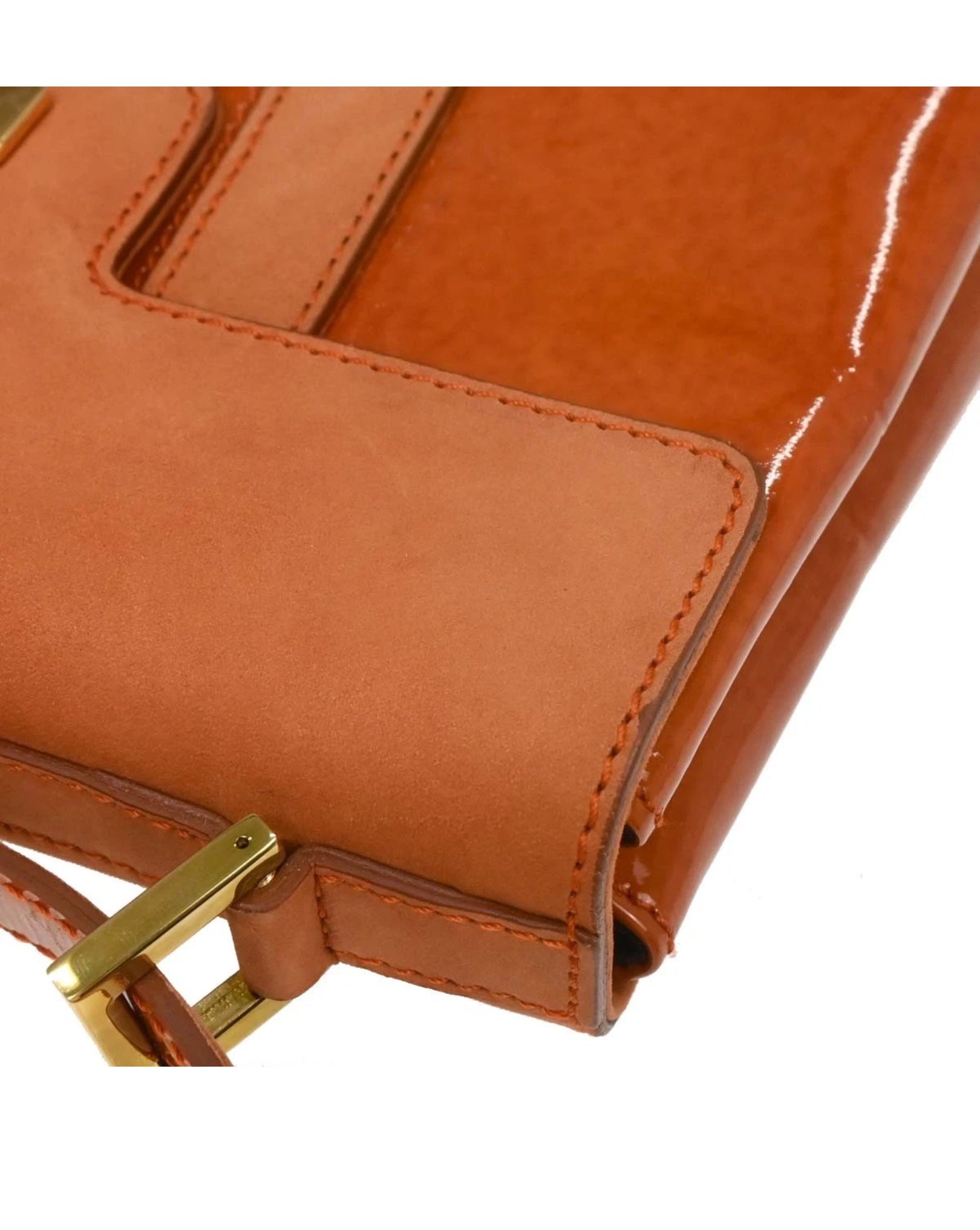 Close-up of leather handbag with a gold buckle